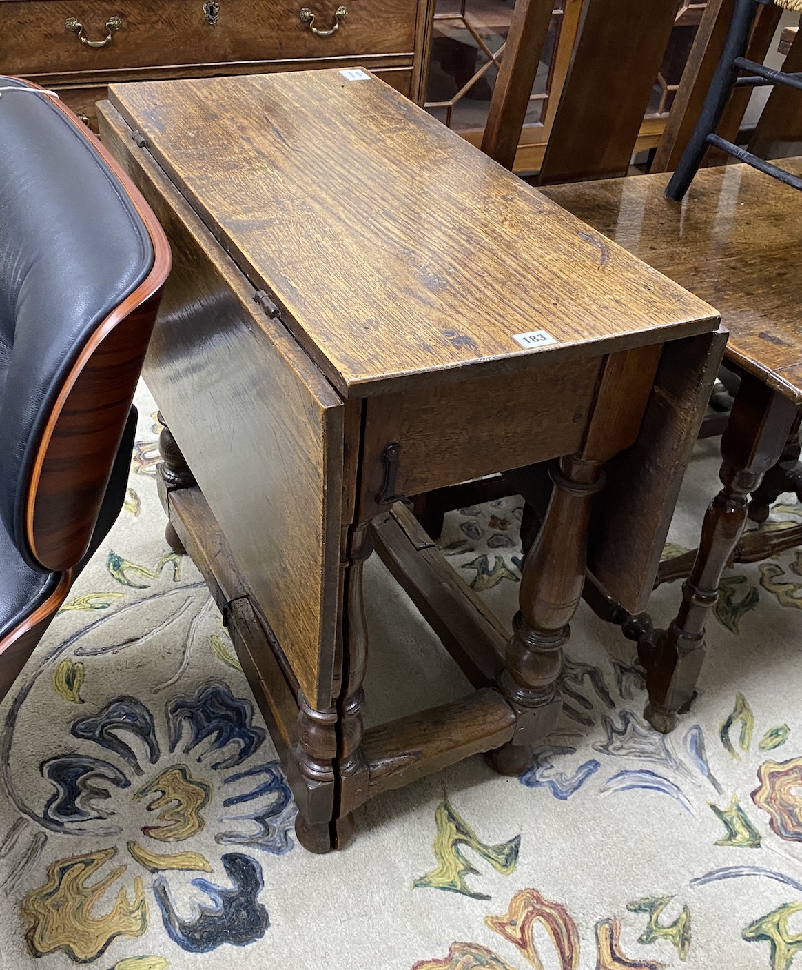 A late 17th century William and Mary oak rectangular gateleg table, the four baluster turned supports with split profile gatelegs, width 77cm, depth 41cm, height 74cm